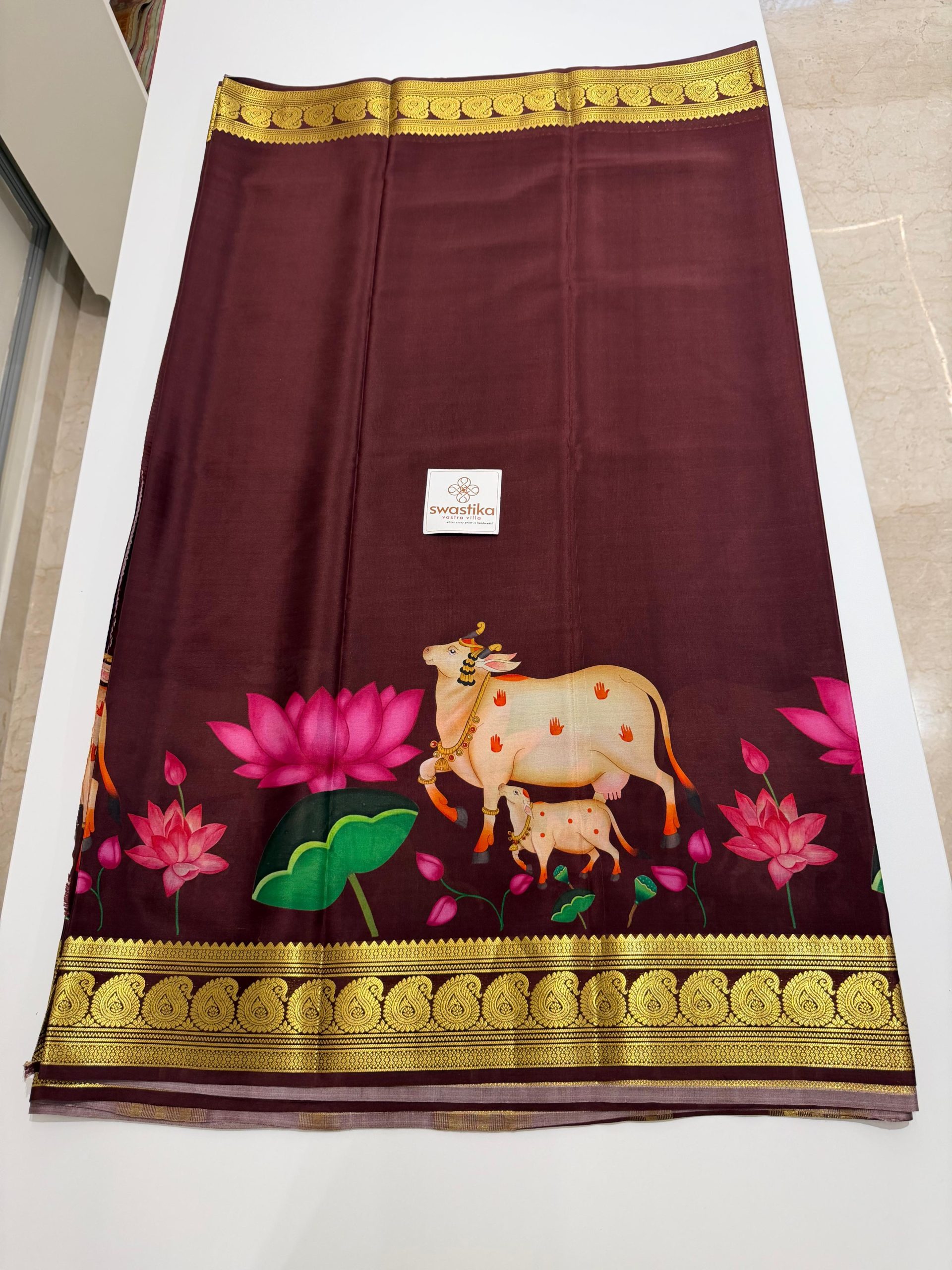 Pure Mysore Silk Saree - (A majestic silk saree an artistic Pichwai motif and blooming lotuses, finished with ornate gold zari borders for a divine traditional appeal.)